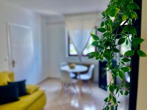 a living room with a table and a plant at Apartment Bellaria in Jadranovo