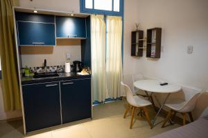 a small kitchen with a table and a table and chairs at HYGGE FORMOSA in Formosa +35 photos