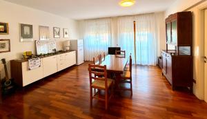 a kitchen with a table and a dining room at ZENIT Rooms in Senigallia