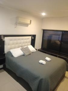 a bedroom with a bed with two towels on it at Casa calle San José in Gualeguaychú