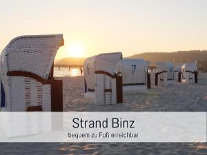a group of chairs sitting on the beach at Appartementhaus Gutenberg - Ruhig & zentral in Binz - Parkplatz kostenlos - 6 Min zum Ostseestrand in Binz