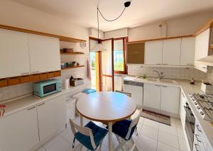 a kitchen with a table and chairs in it at ZENIT Rooms in Senigallia