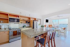 a kitchen with a large island with a counter top at Dog-Friendly Villa with Heated Outdoor Pool, Hot Tub, Streaming, Balcony, Grill in Rosarito