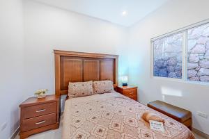 a bedroom with a bed and a window at Dog-Friendly Villa with Heated Outdoor Pool, Hot Tub, Streaming, Balcony, Grill in Rosarito