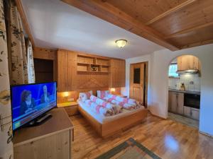 a living room with a couch and a flat screen tv at Orterhof in Obertilliach