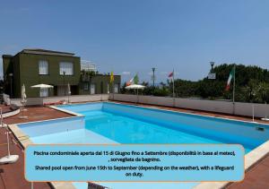 a large swimming pool on top of a building at Soft Comfort - Free Garage - Aria Condizionata - Smart TV in Varazze