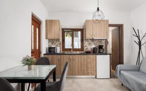 a kitchen with a table and a dining room at Utopia Suites in Egina