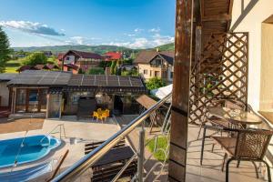 a balcony with a view of a house with a solarium at Casa Bocskai-Vendégház in Sovata