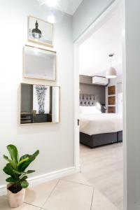 a bedroom with a bed and a mirror at Avemore Jan Cats No 3 in Stellenbosch