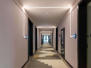 a corridor of an office building with a long hallway at Mercure Chengdu Xindu in Chengdu