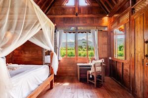 a bedroom with a bed and a desk and windows at Green Labak 1 in Silebeng +58 photos