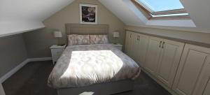 a bedroom with a bed and a skylight at Sli Na Mara in Galway
