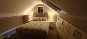 a small bedroom with a bed in a attic at Sli Na Mara in Galway