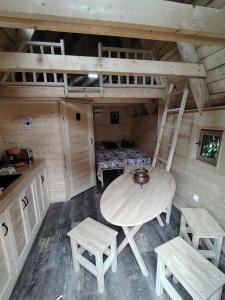 a room with a table and chairs in a cabin at La chaumière ensorcelée in Anor +14 photos