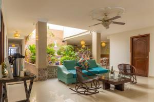 a living room with a blue couch and a table at Olas del Mar Hotel by GHO Hoteles in Santa Marta