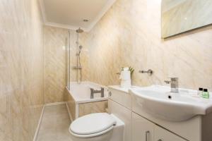 a bathroom with a sink and a toilet and a shower at Scott Suite - Donnini Apartments in Kilmarnock