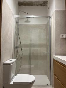 a bathroom with a shower with a toilet and a sink at Central Bilbao, 3min walk to Guggenheim with AC in Bilbao