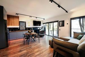a living room with a couch and a table at Paltinu Lake Villas in Teşila +20 photos