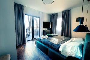 a hotel room with a bed and a large window at Paltinu Lake Villas in Teşila
