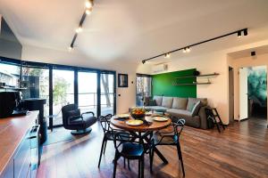 a kitchen and living room with a table and chairs at Paltinu Lake Villas in Teşila