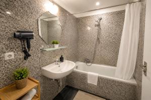 a bathroom with a sink and a bath tub and a sink at Apartment Hotel in Nuremberg +18 photos