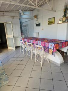 a table with a colorful table cloth on it in a kitchen at Villetta maddalena in Lecce +1 photo
