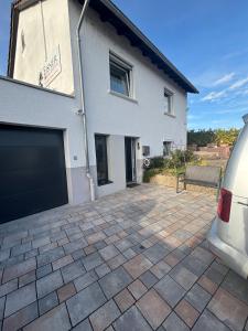a white house with a parking lot in front of it at Small 45 M² Apartment in Bad Kreuznach