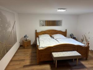 a bedroom with a wooden bed in a room at Small 45 M² Apartment in Bad Kreuznach