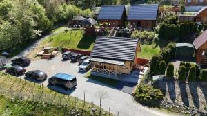 an aerial view of a house with cars parked in a parking lot at Domek u Pusi z jacuzzi in Solina