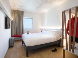 a bedroom with a large white bed and a window at Ibis Abdelmoumen Casa Centre in Casablanca +125 photos