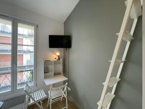 a room with a book shelf and a window at Hôtel My Suite Paris in Paris