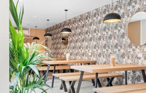 a restaurant with wooden tables and potted plants at Clanbrassil Townhouse in Dundalk