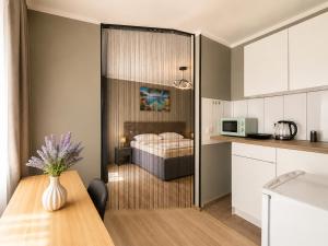 a kitchen and a bedroom with a bed in a room at Apartment Hotel in Nuremberg