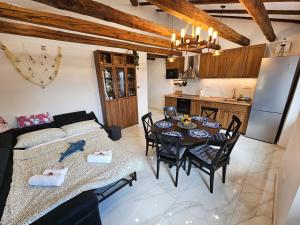 a kitchen and a living room with a table and chairs at Fisherman's Lounge in Izola