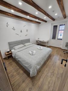 a bedroom with a bed and a desk in it at Fisherman's Lounge in Izola