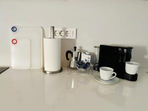 a kitchen counter with two coffee cups and a microwave at Ankaran Studio Escape in Ankaran