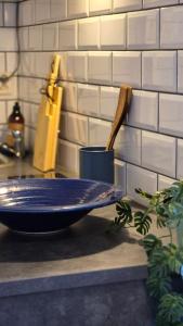 a blue bowl on a counter with a wooden spatula at Cute Mini Studio in Kristiansand