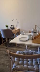 a table with plates and bowls on top of it at Cute Mini Studio in Kristiansand