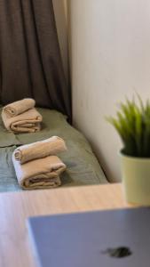 three folded towels sitting on a bed in a room at Cute Mini Studio in Kristiansand +21 photos