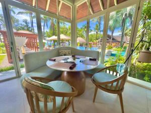 a dining room with a table and two chairs at Niva Labriz Seychelles in Silhouette Island