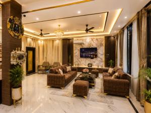 a living room with couches and a tv at Hotel Prabh Aasra Near Shree Ram Mandir in Ayodhya