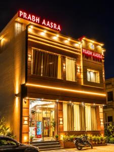 a building with a motorcycle parked in front of it at Hotel Prabh Aasra Near Shree Ram Mandir in Ayodhya