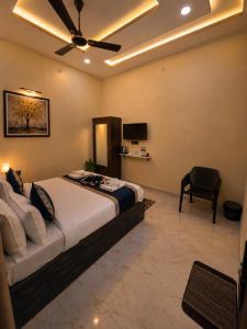 a bedroom with a bed and a ceiling fan at Hotel Prabh Aasra Near Shree Ram Mandir in Ayodhya
