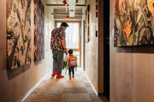 a man and a child walking down a hallway at Sume by Larsen in Tallinn