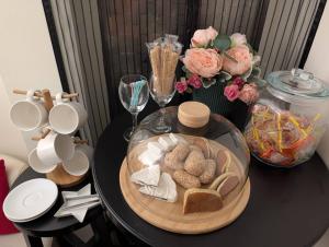 a black table with a plate of food and flowers at Travel Light in Tainan