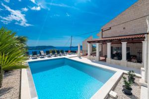 a swimming pool in the backyard of a house at Villa Konstantina in Orasac