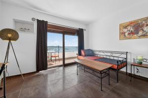a room with a bed and a table and a balcony at Villa Konstantina in Orasac