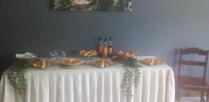a table with food and bottles of wine on it at Residencial Beleza in Mindelo +10 photos
