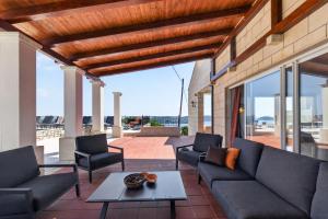 a living room with couches and a table at Villa Konstantina in Orasac