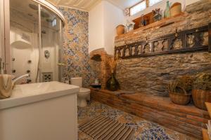 a bathroom with a sink and a brick wall at Leda Hamam House in Plomari +127 photos